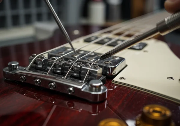 Close-up of guitar bridge for intonation adjustment