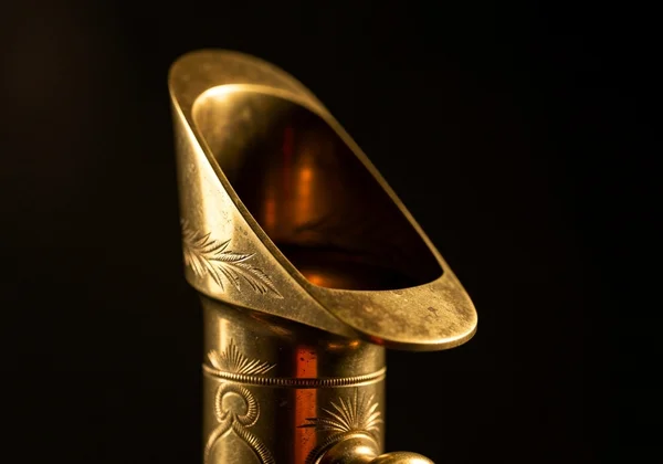 Close-up of hand adjusting saxophone mouthpiece on cork