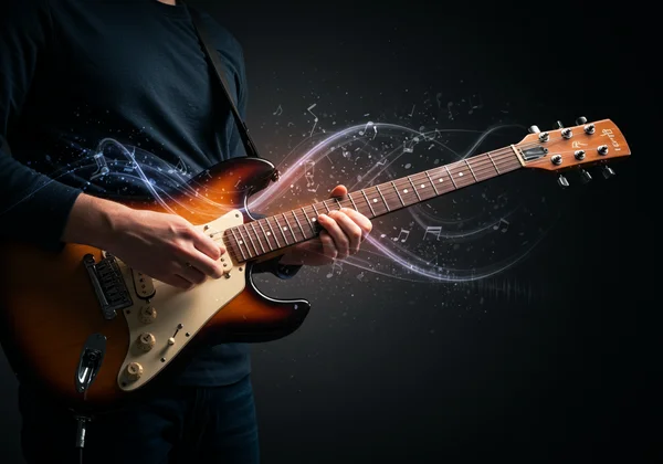 Creative guitar player exploring new sounds with alternate tuning
