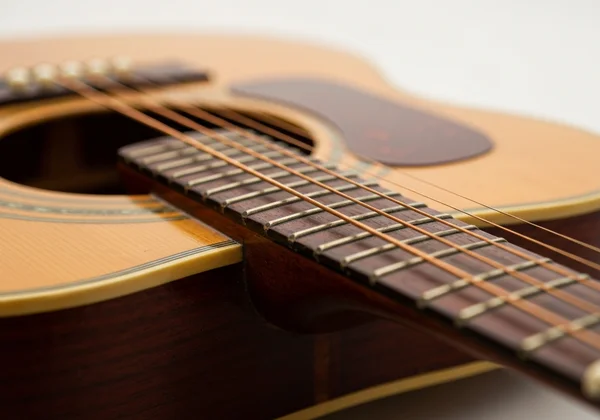 Close-up of hands changing strings on an acoustic guitar