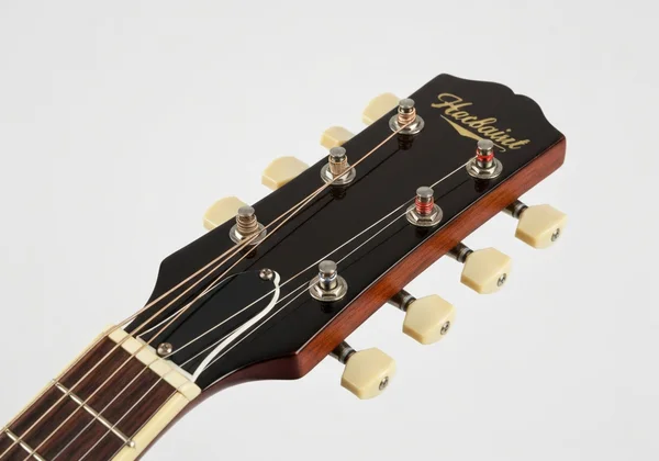 Close-up of guitar headstock with strings wrapped correctly